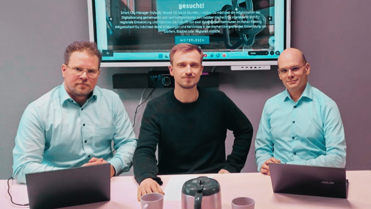 Three men sitting at a table